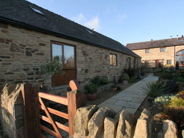 Tilt and Turn windows in country home with shrub garden and slab pathway