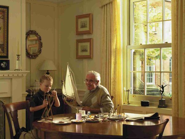 family in their home with Georgian sash windows