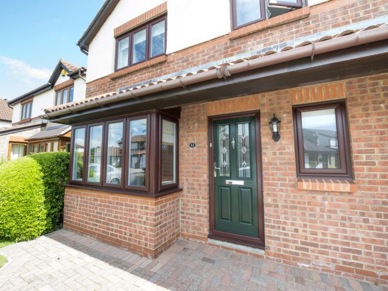Double Glazing Supplier Portsmouth showing VEKA range with brown casement windows and green front door